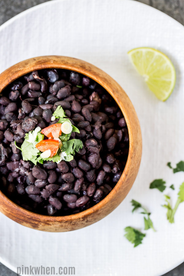 Black Beans from the Instant Pot in a bowl and on a plate ready to serve. 