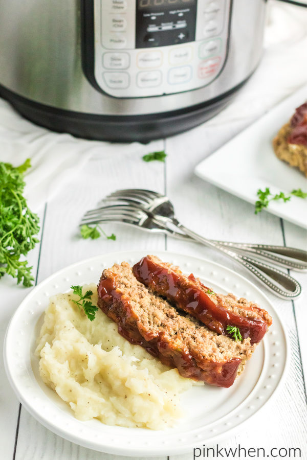 Instant Pot Meatload recipe sliced and served with mashed potatoes on a white plate.
