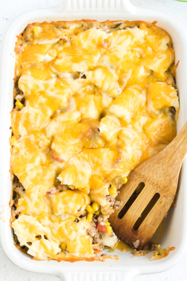 Taco Casserole on a dosh missing a scoop. 