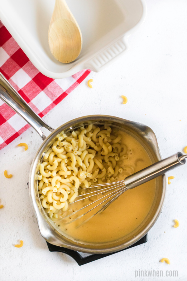 cheese sauce and noodles in saucepan.
