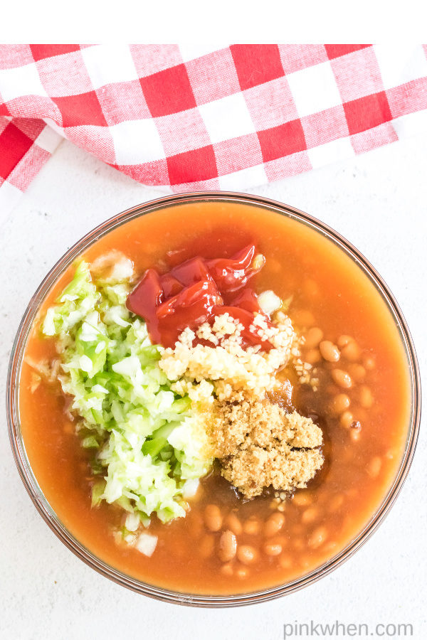Ingredients in a bowl being used to create baked beans.