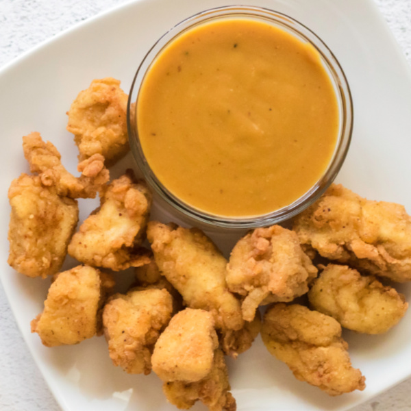 Chick Fil A Sauce and nuggets on a white plate