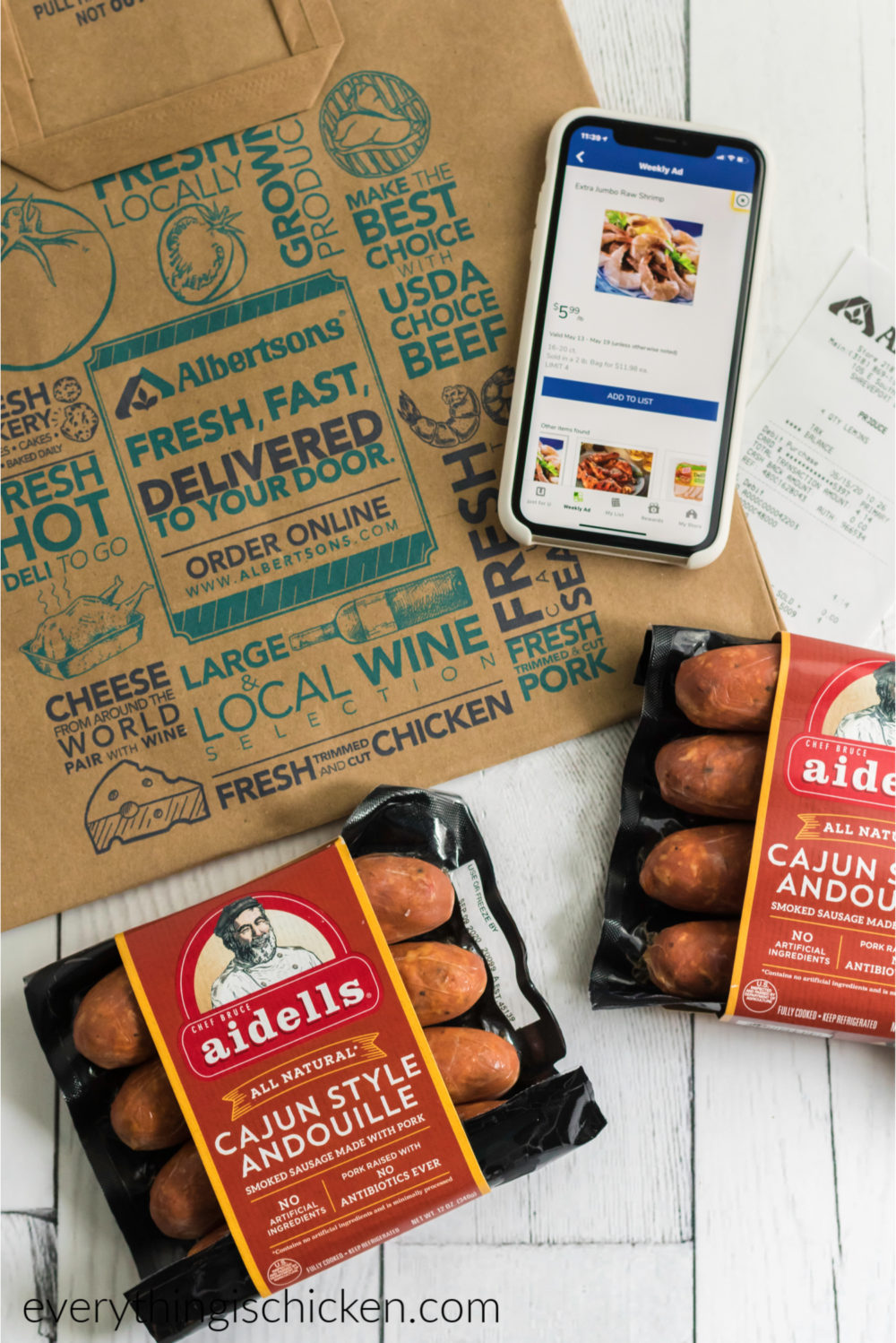 Phone with Alberstons app pulled up. Grocery bag. And sausage. 