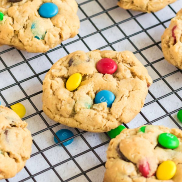 Monster cookies on a wire cooling rack.