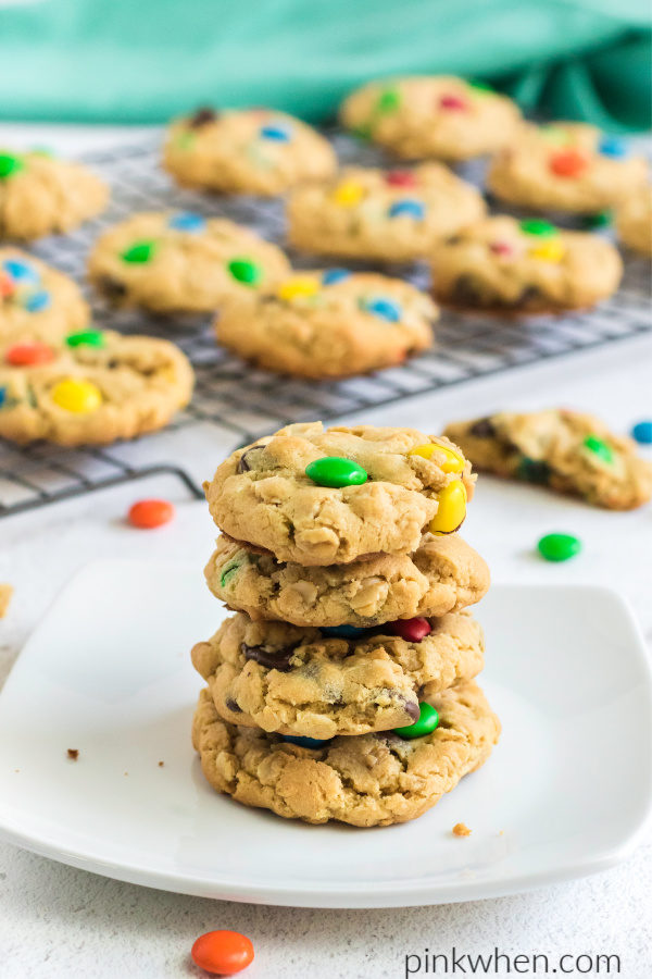 monster cookies stacked on a plate.