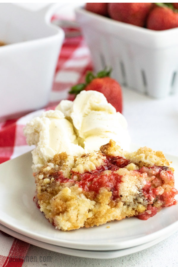 Strawberry cobbler scooped with vanilla ice cream.