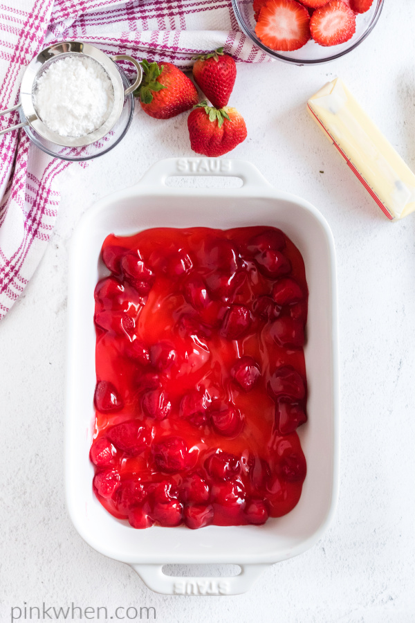 Can of strawberries at the bottom of a 9 x 13 dish.