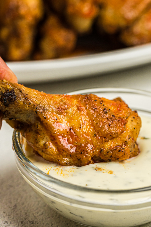 Air Fryer Chicken Wing dipping in ranch dressing.