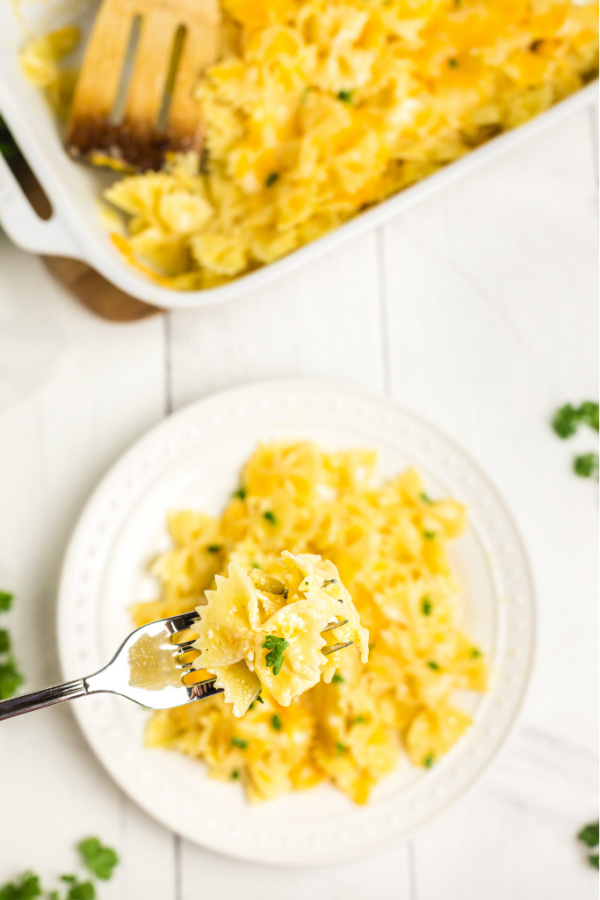 Plate and fork with a bite of mac and cheese. 