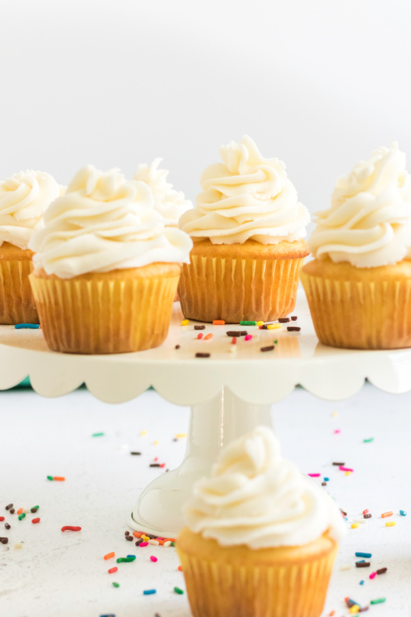 Buttercream frosted cupcakes on a cake stand. 