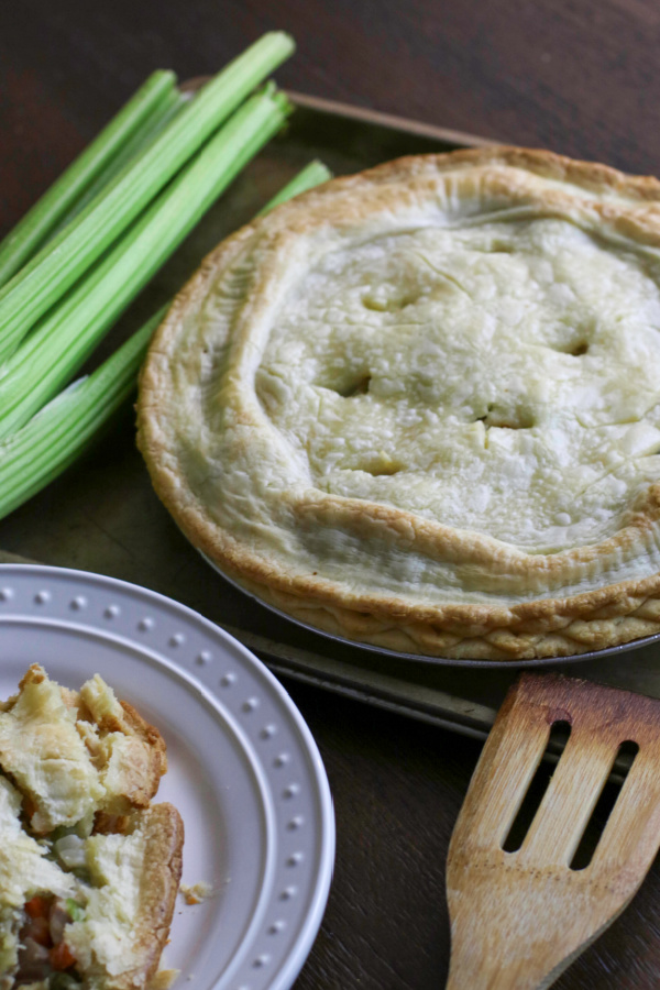 Chicken pot pie on a cookie sheet and ready to slice. 