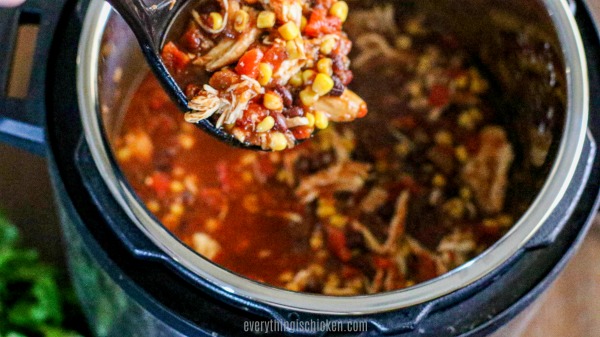 Chicken chili being scooped to serve.