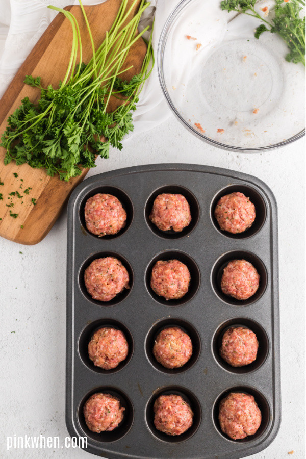 Italian meatballs packed together and in a muffin tin.