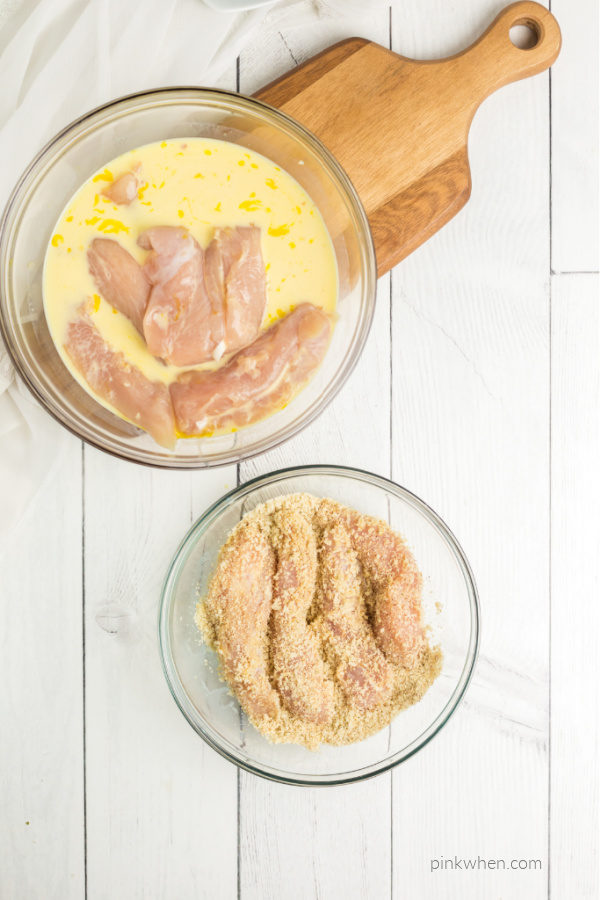 Chicken strips dipped into flour mixture.