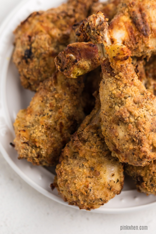 Air Fryer Chicken legs on a white plate.