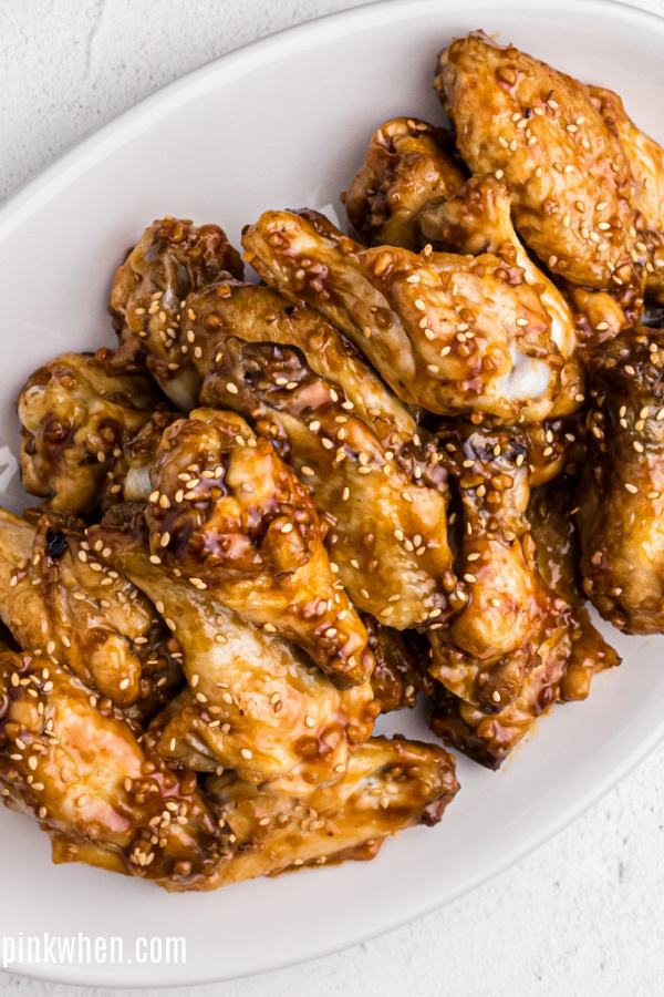 Cooked Air Fryer Chicken Wings with Honey Garlic sauce on a white plate. 