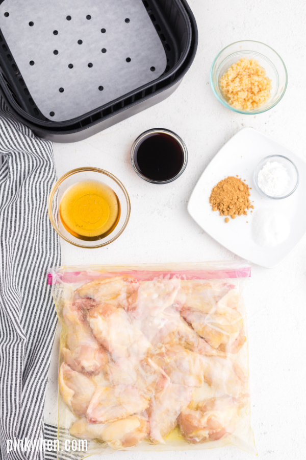 Wings in a sealed bag soaking in olive oil.