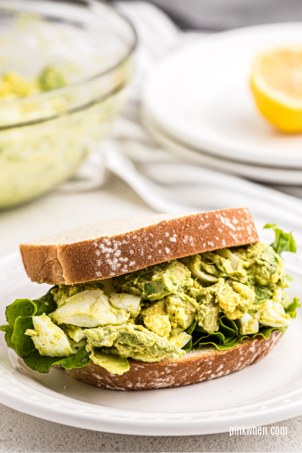Avocado egg salad on bread on a plate.