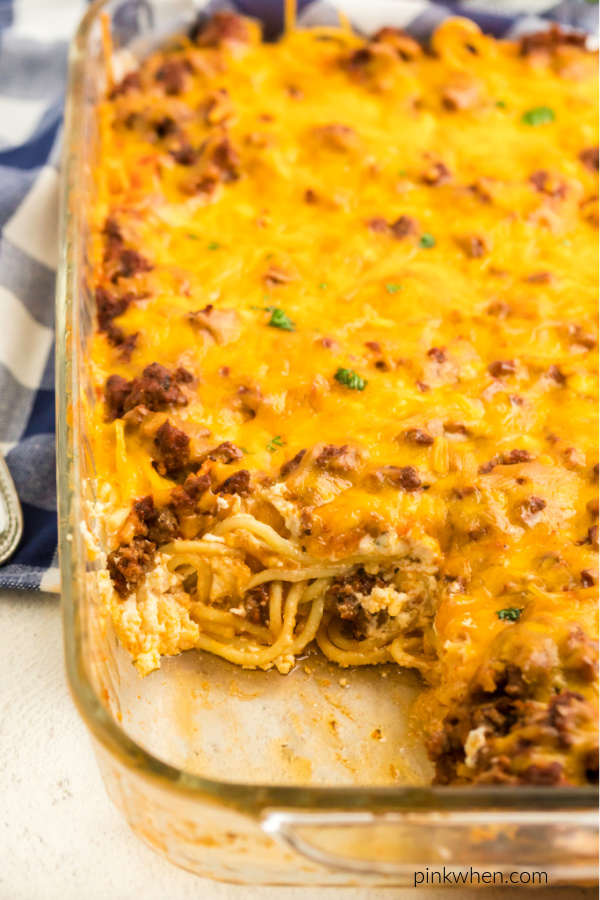 Baked spaghetti missing a slice. 