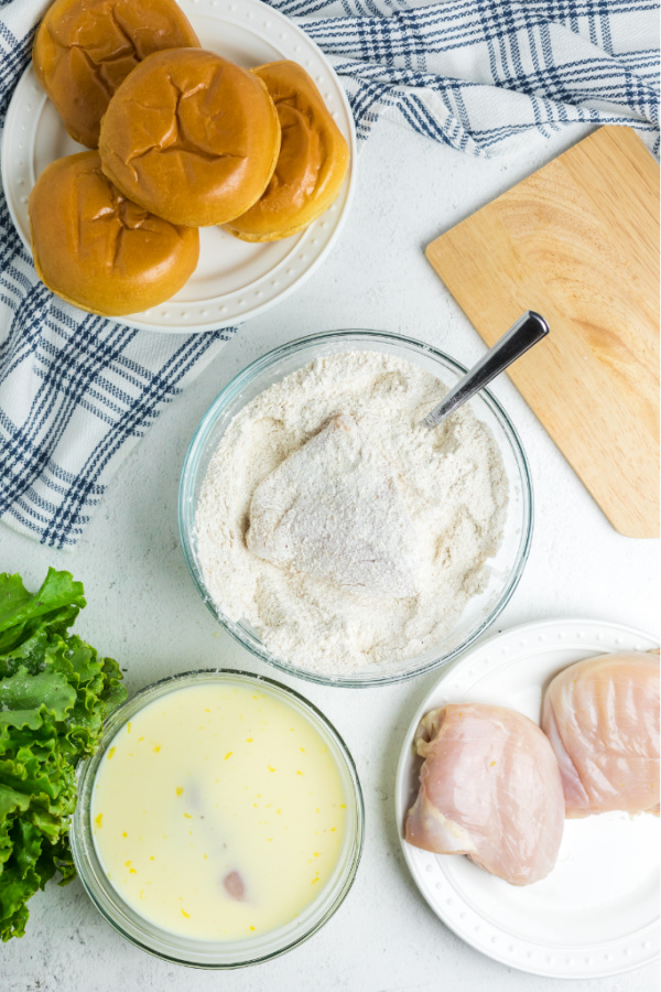 Mixing together chicken with flour mixture.