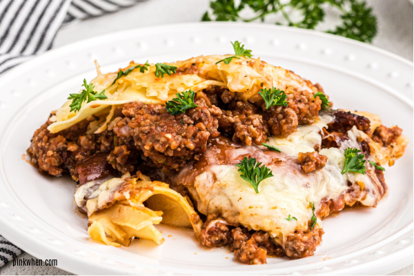Lasagna on a white plate.