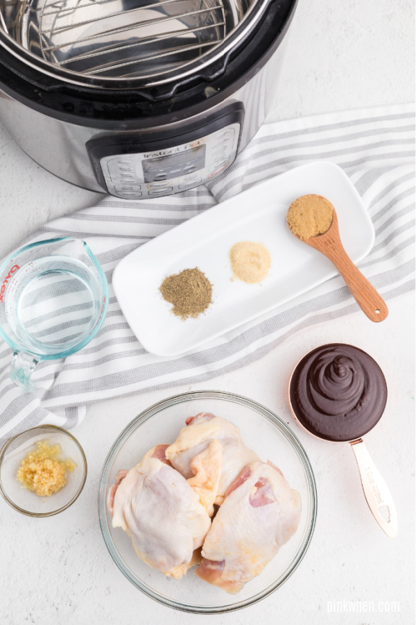 Ingredients laid on a white table used to make Instant Pot BBQ Chicken Thighs. 