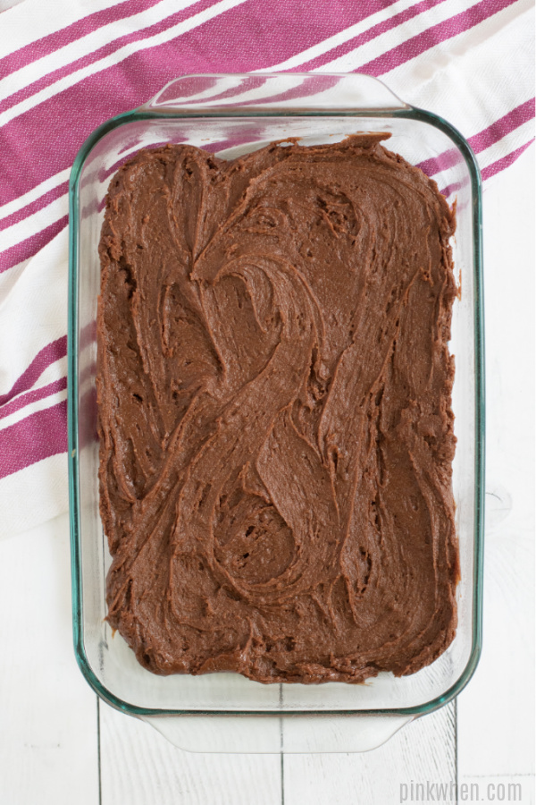 Brownie dough spread in a 9 x 13 dish.