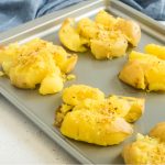 Smashed potatoes on a cookie sheet.