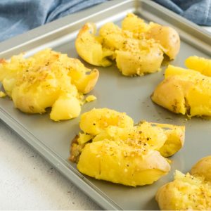 Smashed potatoes on a cookie sheet.