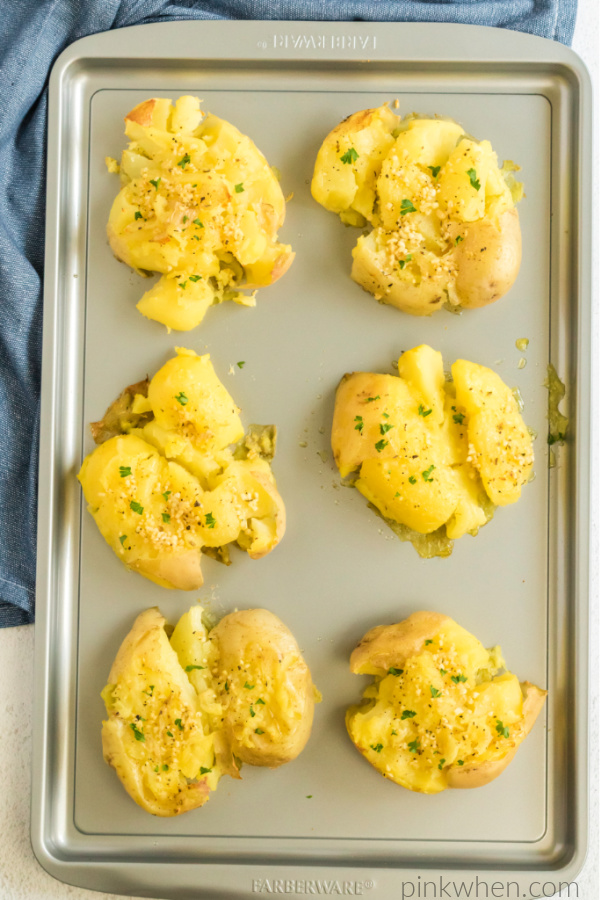 Smashed Yukon potatoes on a sheet pan ready to serve.