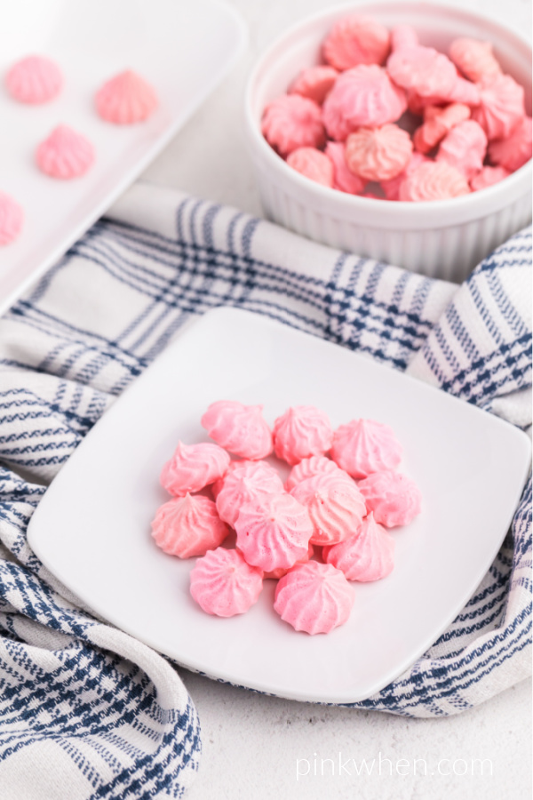Pink meringue cookies on a white plate ready to serve.