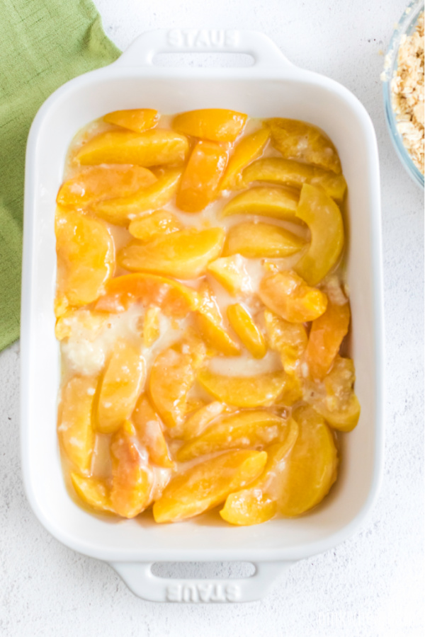 Peach mixture poured into a 9 x 13 baking dish