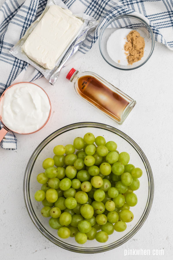Ingredients needed for grape salad with cream cheese, sugars, vanilla, and sour cream. 
