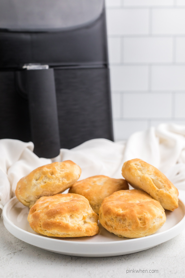 Biscuits cooked in an Air Fryer on a white plate ready to serve.