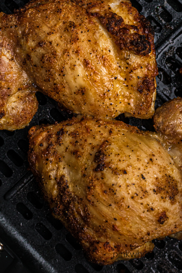 Cooke Chicken Thighs in the air fryer basket. 