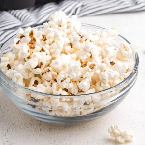 Popcorn in a clear bowl from an air fryer.