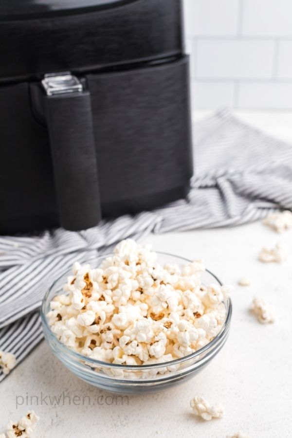 Popcorn in a clear bowl that was popped in an air fryer. 