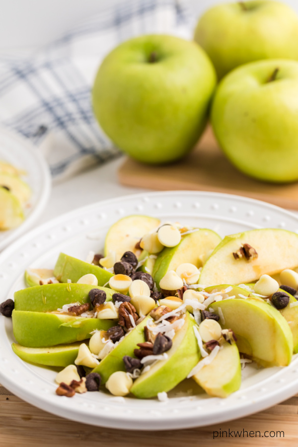 Granny Smith apple slices topped with caramel chocolate, coconut, and more. 
