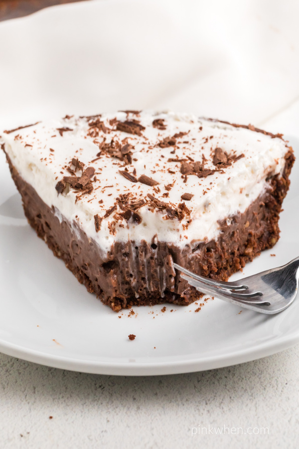 Slice of chocolate cream pie with a slice missing. 