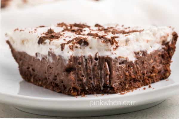 Slice of chocolate cream pie with a bite missing. 
