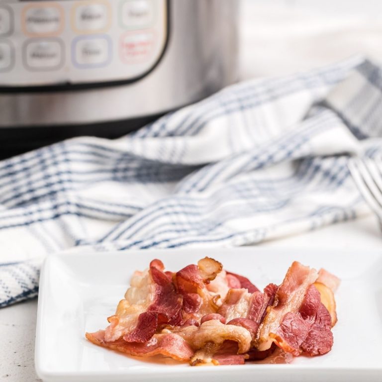 Bacon on a white plate that was made in the Instant Pot.