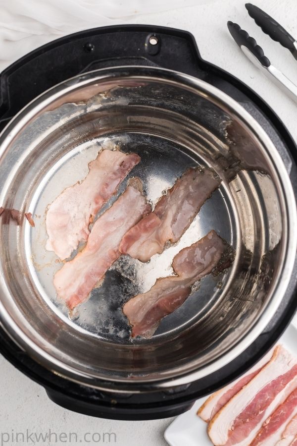 Half slices of bacon in the Instant Pot.