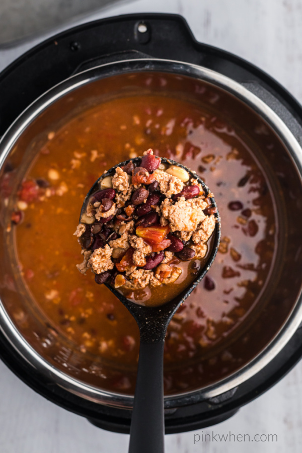Turkey Chili being scooped out of the pressure cooker. 