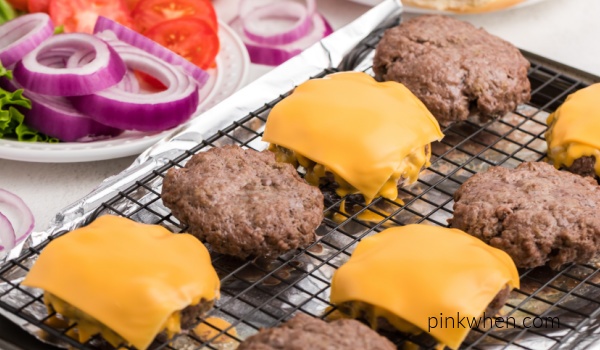 Oven baked hamburgers with cheese and plain that are fully cooked and ready to eat. 