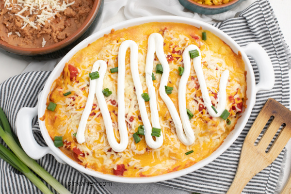 Fully cooked chicken taco casserole recipe in a white casserole dish ready to serve.