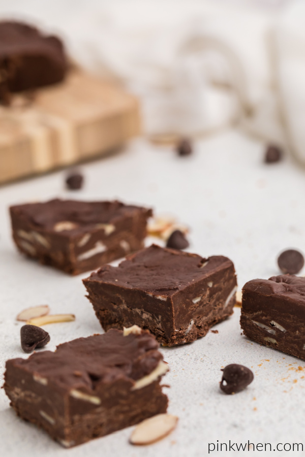 Chocolate almond fudge scattered on  a white table.