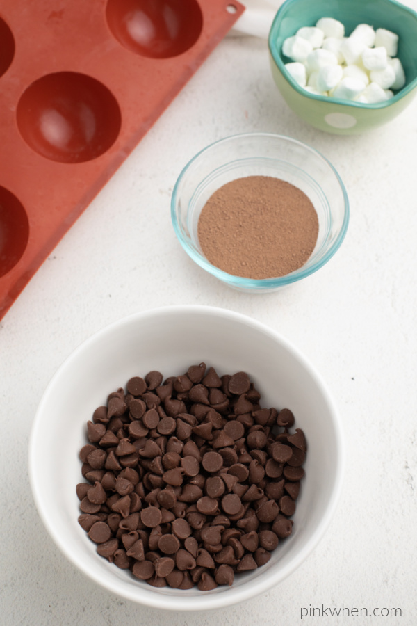 Ingredients and the mold needed to make hot cocoa bombs.