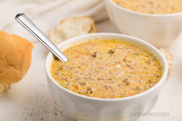 Instant Pot Cheeseburger Soup in white bowls with french bread. 