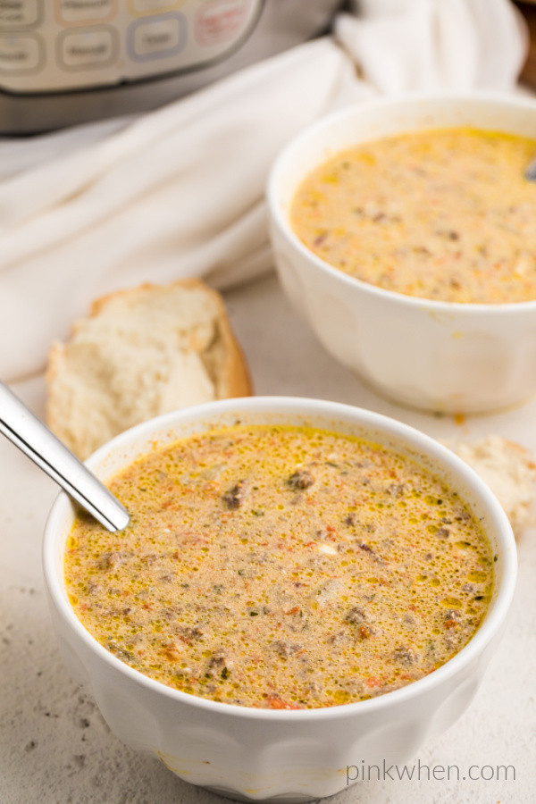 Cheeseburger soup in a white bowl ready to eat. 