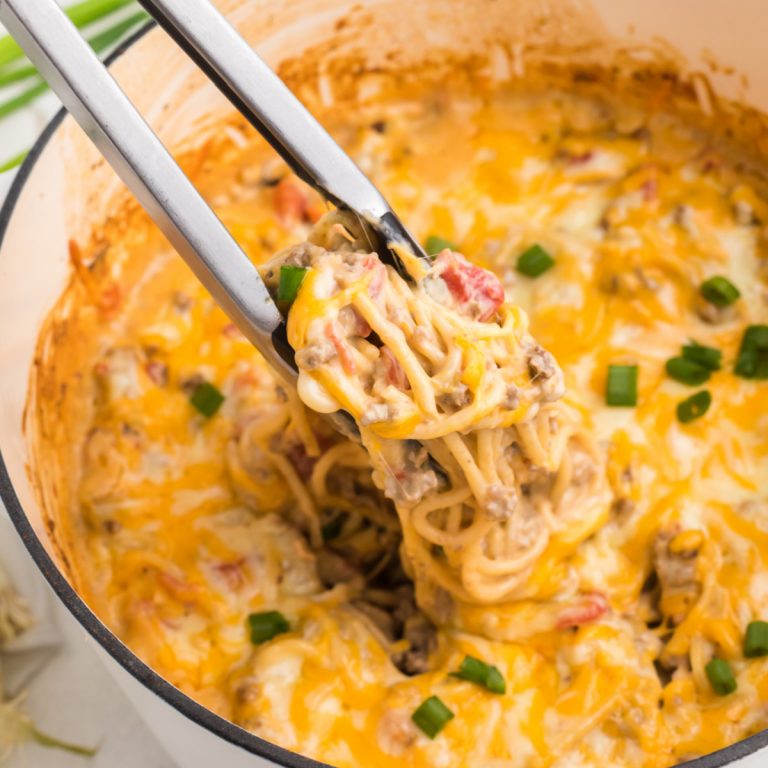 Taco Spaghetti in a dutch oven being scooped for serving.